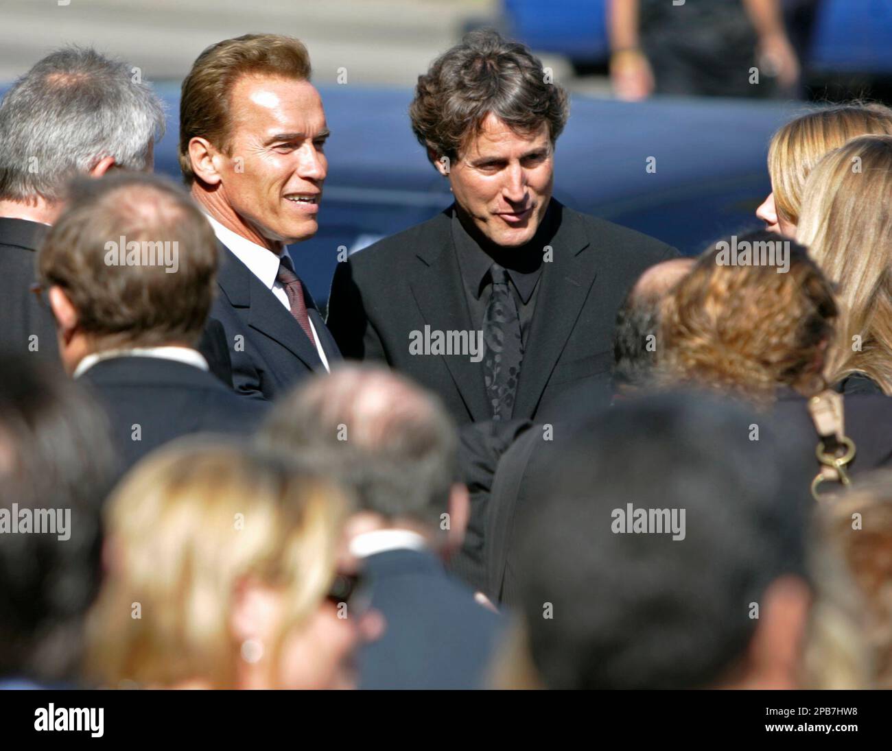 Gov. Arnold Schwarzenegger, left, and Merv Griffin's son, Tony, talk to